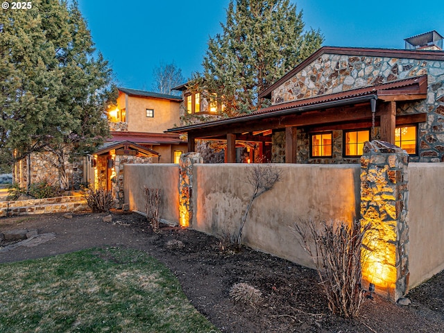 23021 Brushline Ct, Bend, OR 97701 - view of front of property featuring stone siding and a fenced front yard