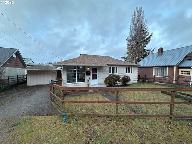 view of front facade featuring an outbuilding and a front lawn