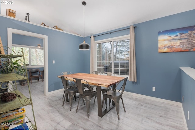 dining space with light wood-type flooring and a wealth of natural light