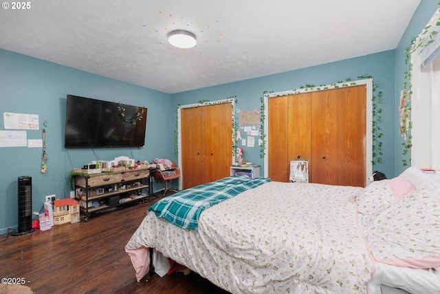 bedroom with dark wood-type flooring and a textured ceiling