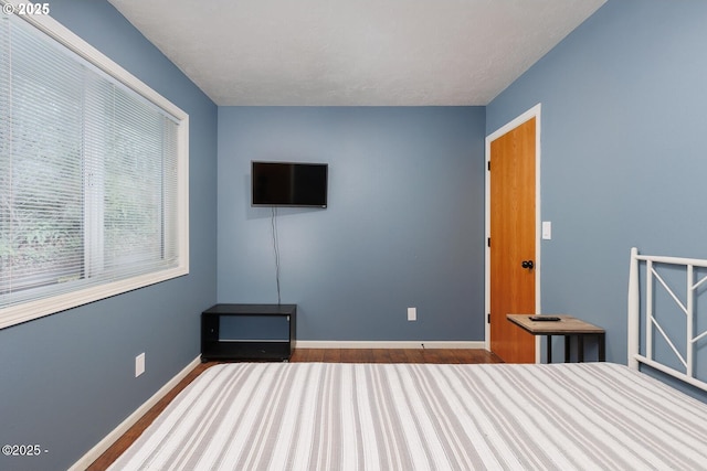 unfurnished bedroom with wood-type flooring