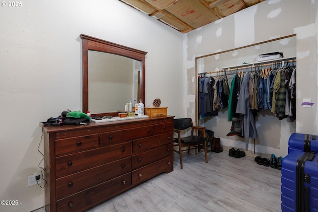 bedroom featuring light hardwood / wood-style flooring and a closet