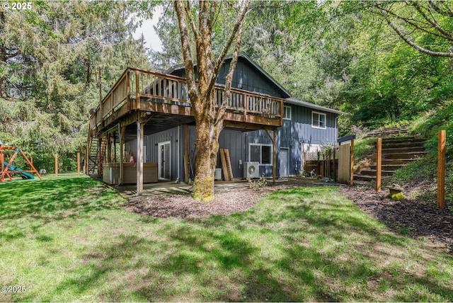 back of property featuring a wooden deck, ac unit, a yard, and a jacuzzi