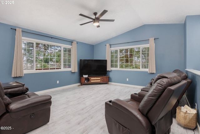 living room featuring ceiling fan, lofted ceiling, and light wood-type flooring