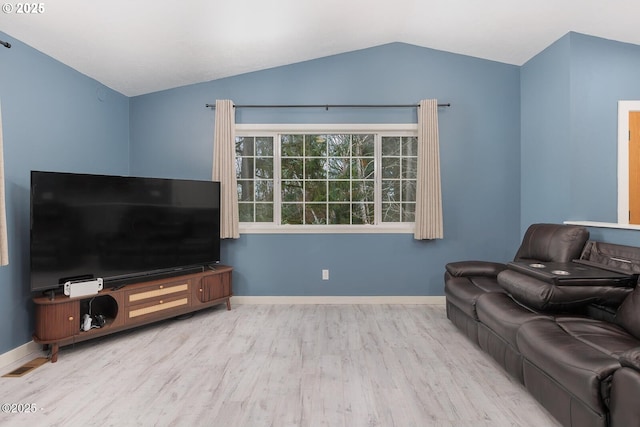 living room with vaulted ceiling and light hardwood / wood-style floors