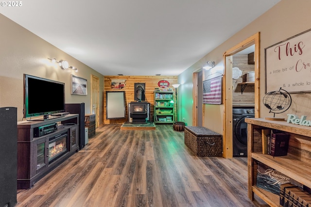 10256 Ridgeview Ter, Birkenfeld, OR 97016 - living room with a wood stove, wood finished floors, and washer / dryer