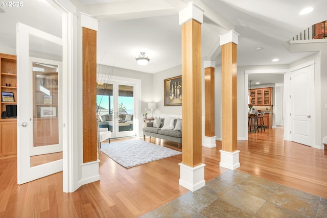 interior space with recessed lighting, baseboards, ornate columns, and wood finished floors