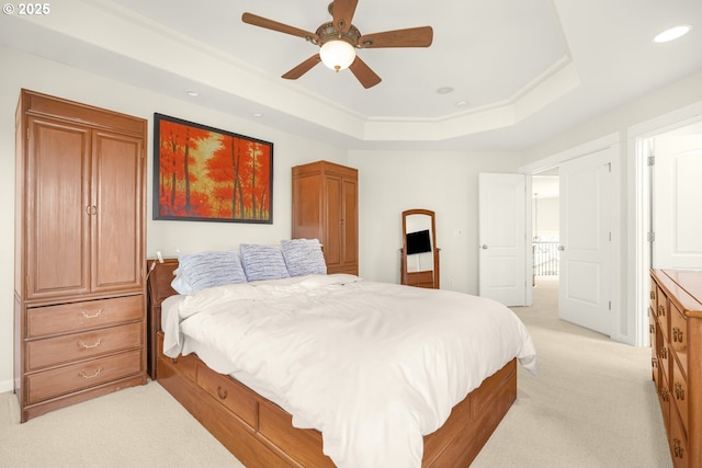 bedroom featuring a tray ceiling, a ceiling fan, light colored carpet, and recessed lighting