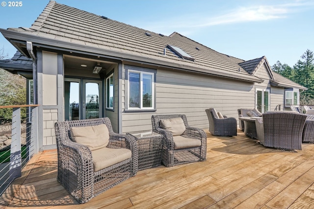 deck with an outdoor living space and french doors