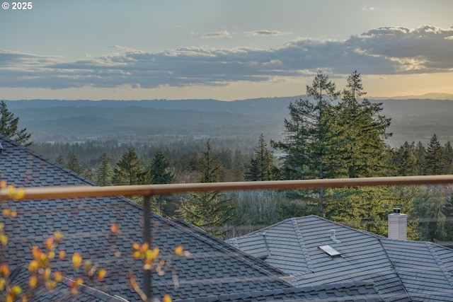 exterior space with a wooded view and a mountain view