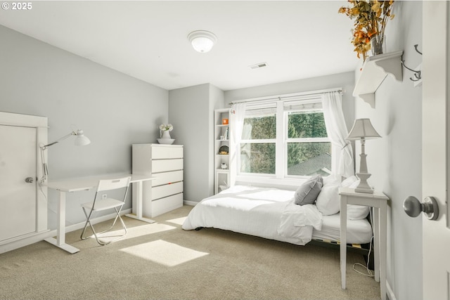 carpeted bedroom featuring visible vents and baseboards