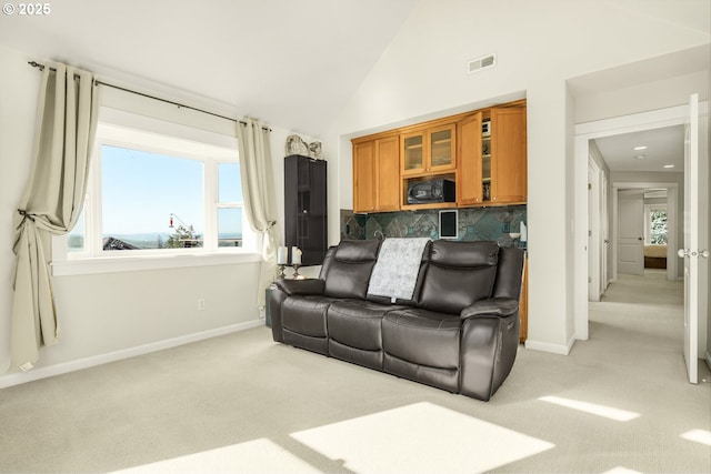 living room featuring light carpet, visible vents, and baseboards