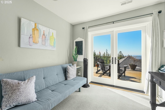 living room featuring french doors and visible vents