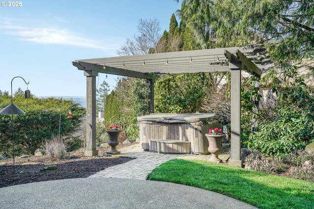 view of patio / terrace featuring a hot tub and a pergola