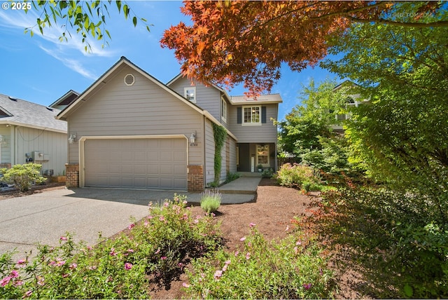 4744 SE Maxwell St, Hillsboro, OR 97123 - view of front of house with an attached garage, asphalt driveway, and brick siding