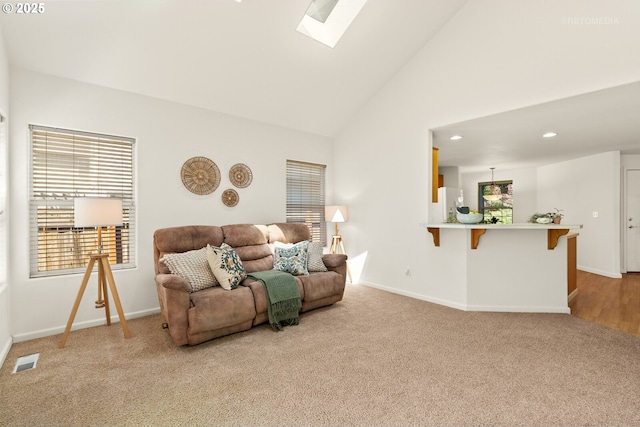 4744 SE Maxwell St, Hillsboro, OR 97123 - living area featuring carpet floors, a skylight, healthy amount of natural light, high vaulted ceiling, and baseboards