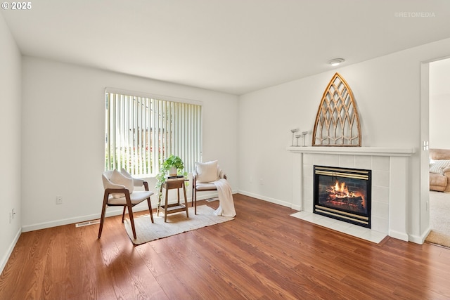 4744 SE Maxwell St, Hillsboro, OR 97123 - living area featuring a tile fireplace, wood finished floors, and baseboards
