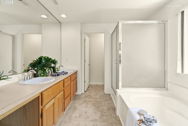 4744 SE Maxwell St, Hillsboro, OR 97123 - bathroom with a garden tub, double vanity, a shower stall, and recessed lighting