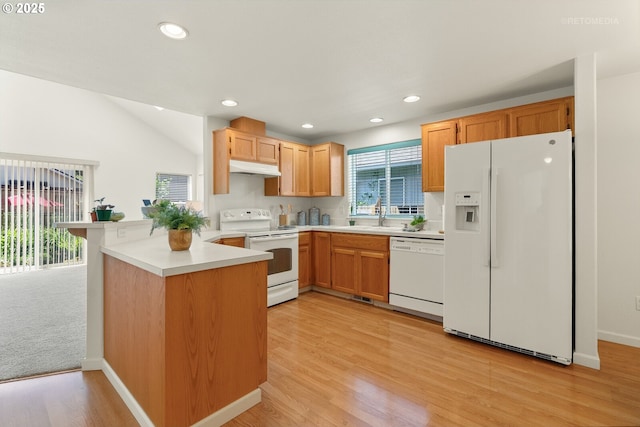 4744 SE Maxwell St, Hillsboro, OR 97123 - kitchen featuring white appliances, a peninsula, under cabinet range hood, light wood-type flooring, and light countertops