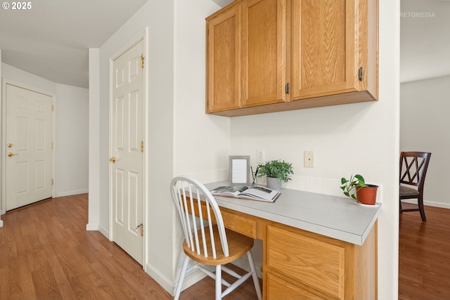 4744 SE Maxwell St, Hillsboro, OR 97123 - home office featuring wood finished floors, baseboards, and built in desk