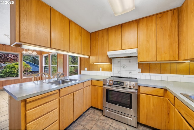 8095 Bewley St, Bay City, OR 97107 - kitchen featuring stainless steel electric stove, under cabinet range hood, a sink, and backsplash