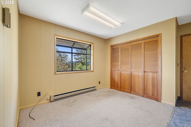 8095 Bewley St, Bay City, OR 97107 - unfurnished bedroom featuring a baseboard heating unit, a closet, carpet, and baseboards