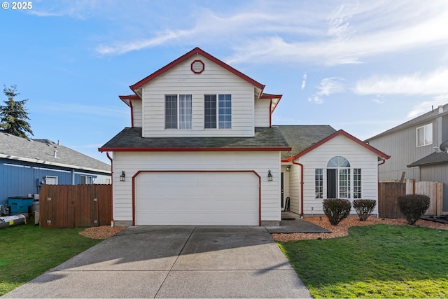 traditional-style home with driveway, fence, and a front yard