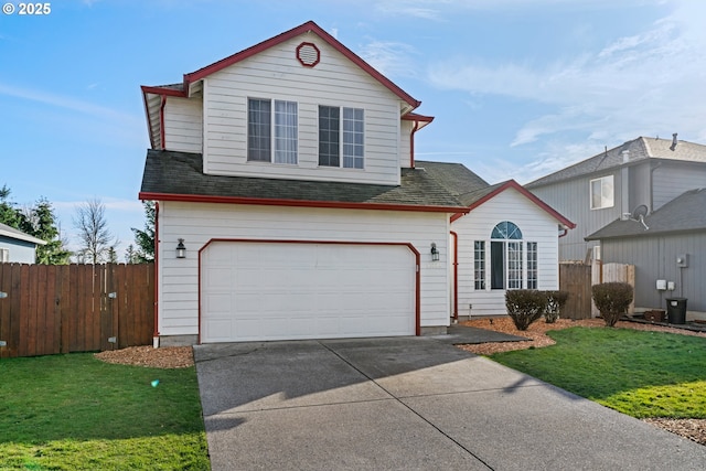 traditional home with roof with shingles, concrete driveway, a front yard, fence, and a garage