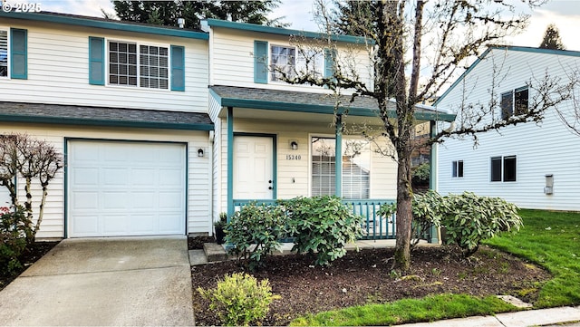 view of front of house with a garage, concrete driveway, a porch, and roof with shingles