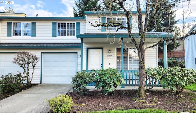 view of front of property with a porch, concrete driveway, and an attached garage