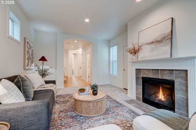 living room featuring a tile fireplace