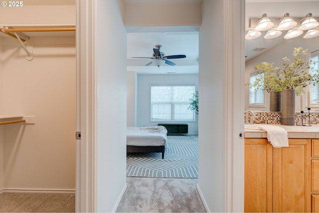 interior space featuring tasteful backsplash, vanity, and ceiling fan