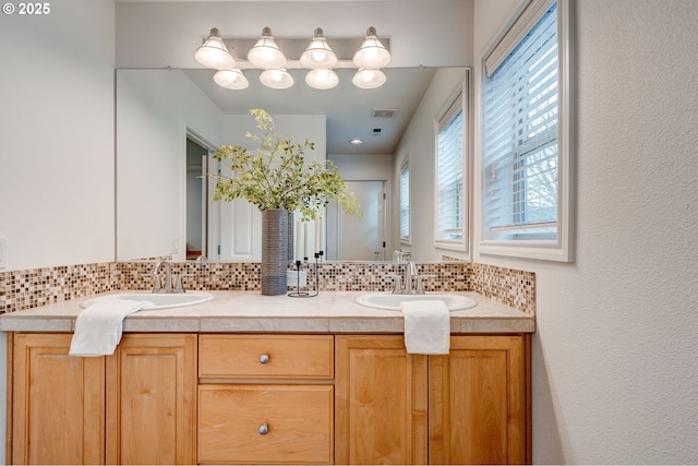 bathroom with vanity and decorative backsplash