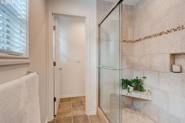 bathroom featuring a shower with door