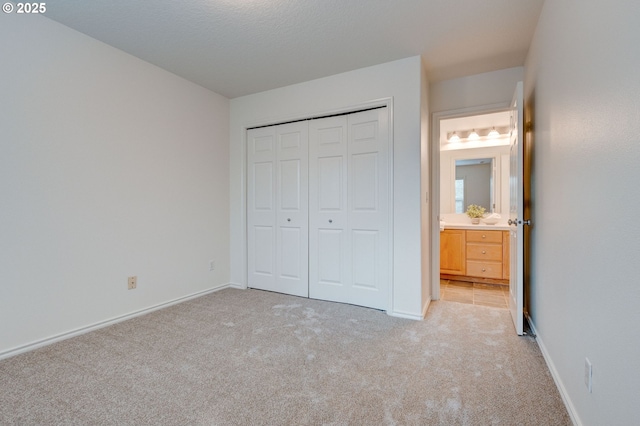 unfurnished bedroom featuring a closet and light carpet