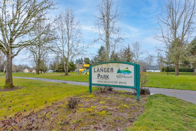 view of property's community featuring a playground and a lawn