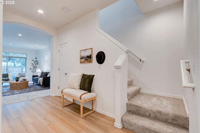 staircase with hardwood / wood-style floors