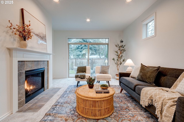 living room with carpet floors and a fireplace