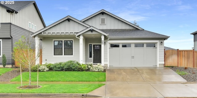 view of front of house with driveway, board and batten siding, a shingled roof, fence, and a front yard