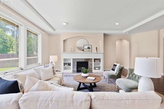 14609 NE 112th St, Vancouver, WA 98682 - living area featuring a tray ceiling, wood finished floors, a fireplace, baseboards, and recessed lighting