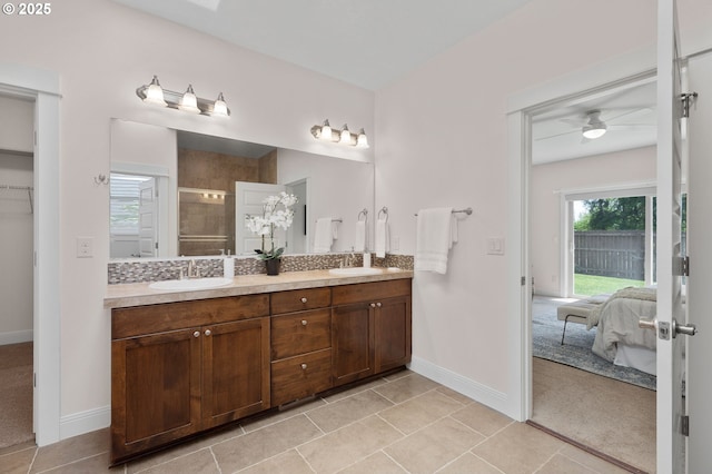 14609 NE 112th St, Vancouver, WA 98682 - full bath with double vanity, a tile shower, baseboards, ceiling fan, and ensuite bathroom