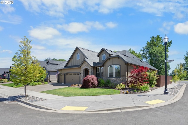 14609 NE 112th St, Vancouver, WA 98682 - craftsman house with stone siding, board and batten siding, concrete driveway, an attached garage, and a shingled roof