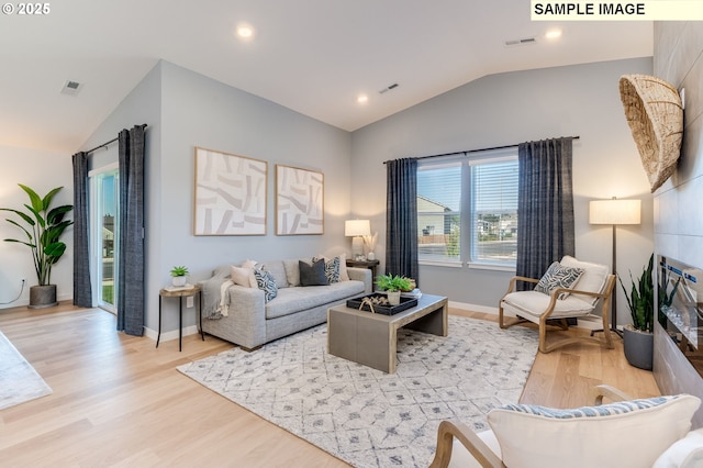 living room with light wood-type flooring, baseboards, visible vents, and vaulted ceiling