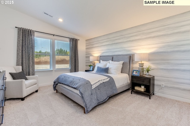 carpeted bedroom featuring baseboards, visible vents, and vaulted ceiling