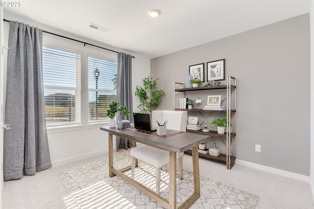 office with visible vents, light carpet, and baseboards