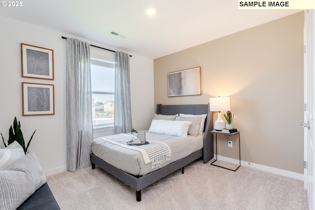 bedroom with baseboards, visible vents, and light colored carpet