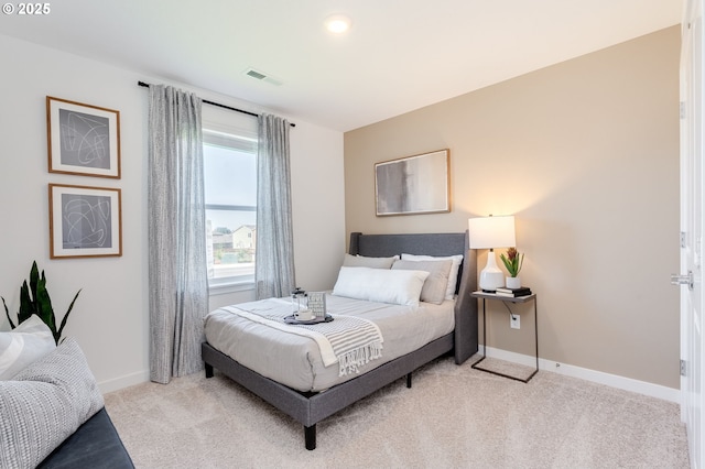 bedroom featuring light carpet, baseboards, and visible vents