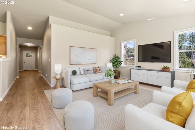51013 Mckenzie Hwy, Vida, OR 97488 - living room featuring arched walkways, light wood-style flooring, plenty of natural light, vaulted ceiling, and recessed lighting