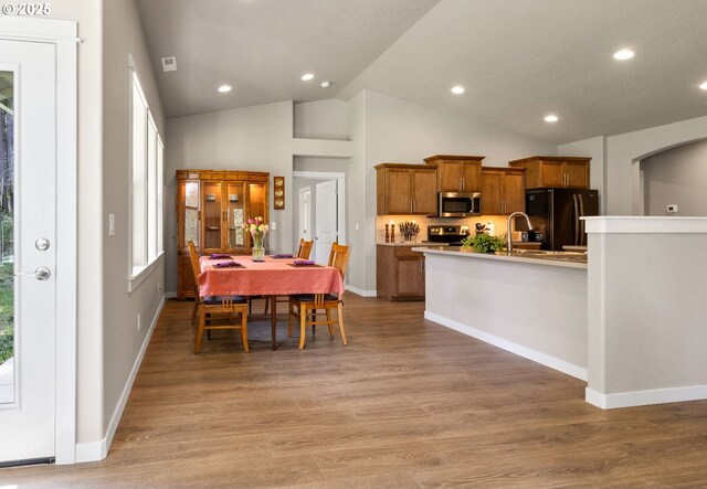 51013 Mckenzie Hwy, Vida, OR 97488 - dining area with light wood-style flooring, baseboards, recessed lighting, arched walkways, and high vaulted ceiling