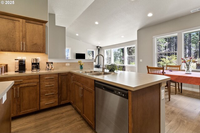 51013 Mckenzie Hwy, Vida, OR 97488 - kitchen with dishwasher, a sink, a peninsula, dark wood finished floors, and vaulted ceiling